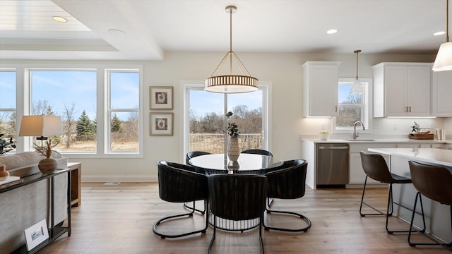 dining space with light wood-style flooring, plenty of natural light, and recessed lighting