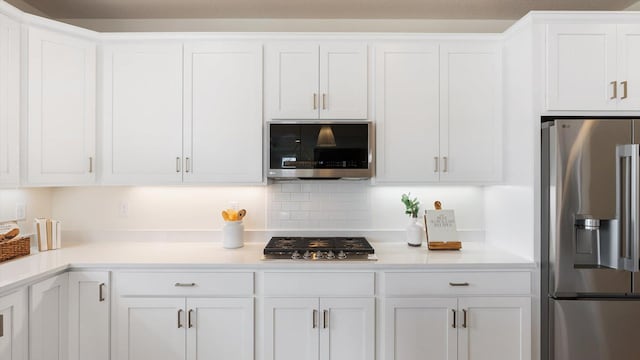 kitchen featuring light countertops, white cabinets, and stainless steel appliances