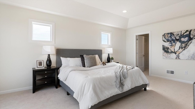 bedroom featuring multiple windows, light colored carpet, visible vents, and baseboards