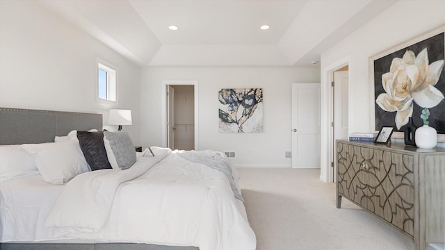 bedroom with visible vents, baseboards, recessed lighting, a raised ceiling, and light colored carpet