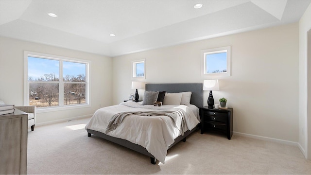 bedroom with recessed lighting, baseboards, a raised ceiling, and light carpet