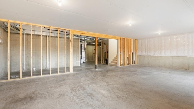 unfinished basement featuring stairs