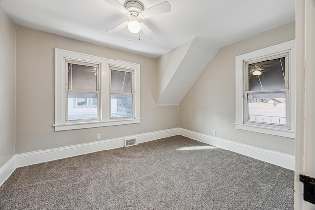 bonus room featuring baseboards, visible vents, ceiling fan, vaulted ceiling, and carpet flooring