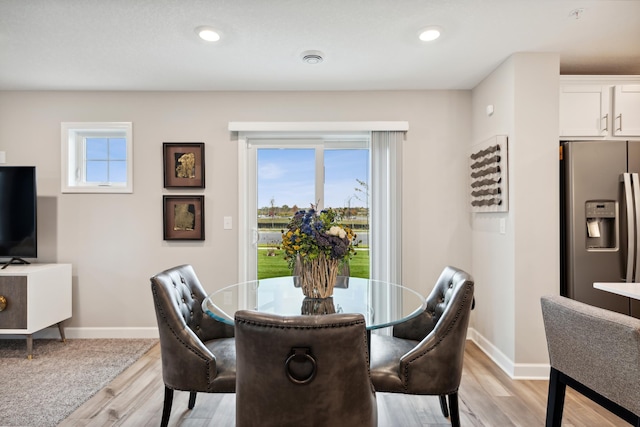 dining room with recessed lighting, light wood-type flooring, and baseboards