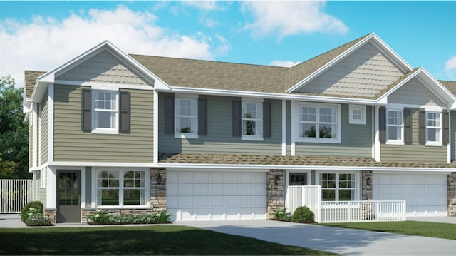 view of front of property with stone siding, concrete driveway, a garage, and roof with shingles