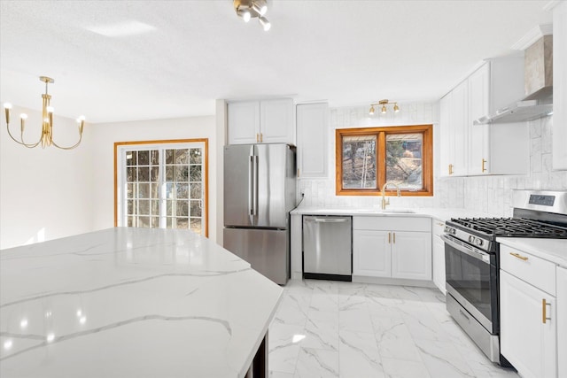 kitchen with decorative backsplash, stainless steel appliances, marble finish floor, white cabinetry, and wall chimney exhaust hood