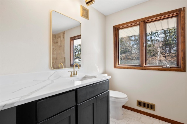 bathroom featuring visible vents, baseboards, toilet, and vanity