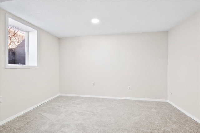 carpeted empty room featuring recessed lighting and baseboards