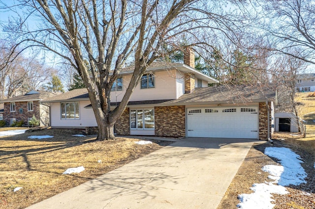 view of front of house featuring driveway, an attached garage, a shingled roof, a chimney, and brick siding