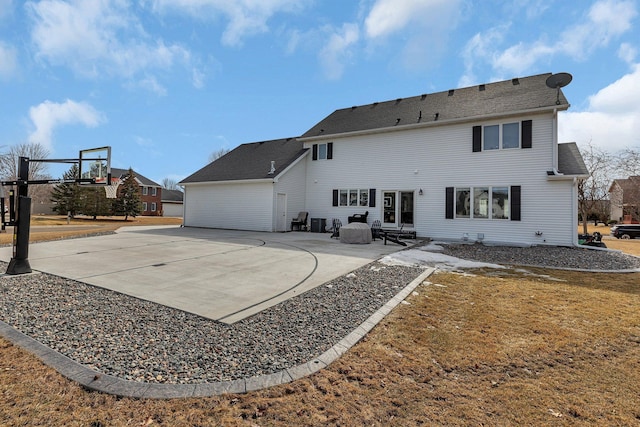 back of property with basketball hoop and a patio area