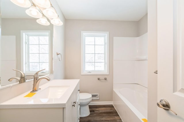 full bath featuring vanity, toilet, wood finished floors, and baseboards