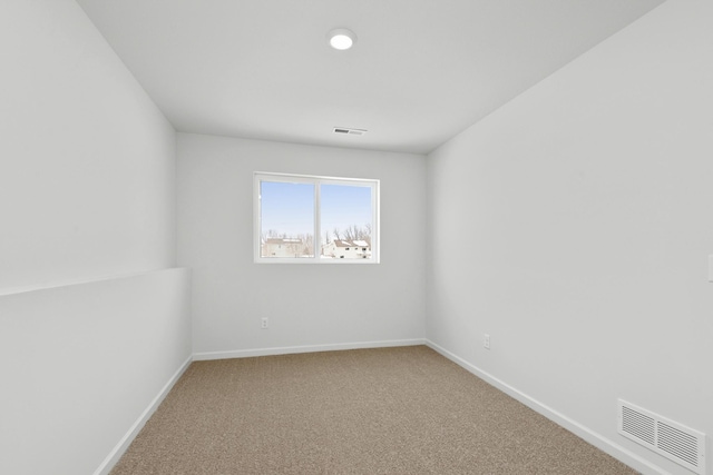 spare room featuring visible vents, baseboards, and carpet floors