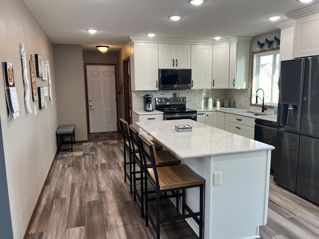 kitchen with fridge with ice dispenser, decorative backsplash, dishwashing machine, electric stove, and wood finished floors