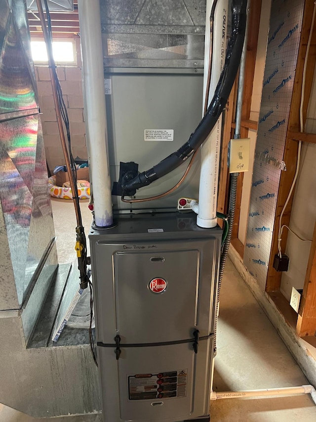 utility room featuring heating unit