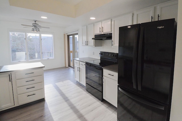 kitchen with black appliances, a ceiling fan, light wood-style floors, and under cabinet range hood