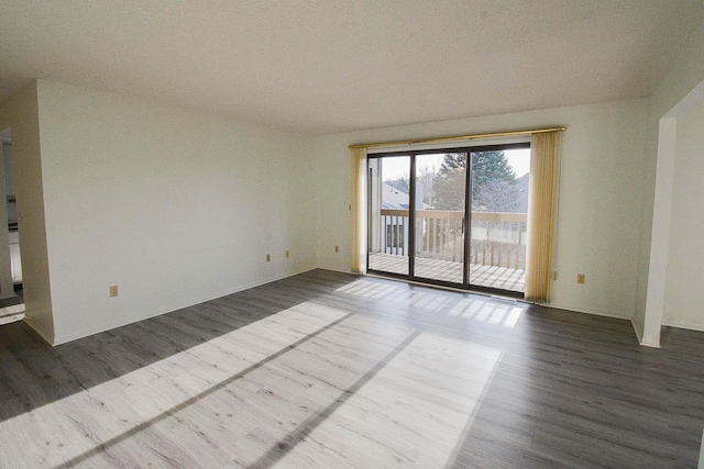 spare room with dark wood-style floors