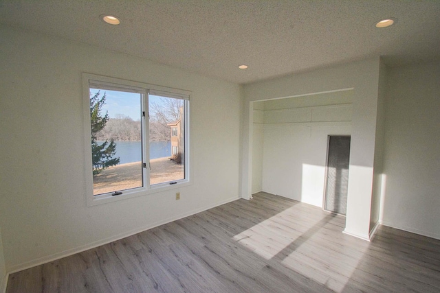 unfurnished room featuring recessed lighting and wood finished floors