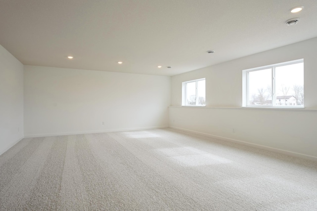 unfurnished room featuring recessed lighting, baseboards, and light colored carpet