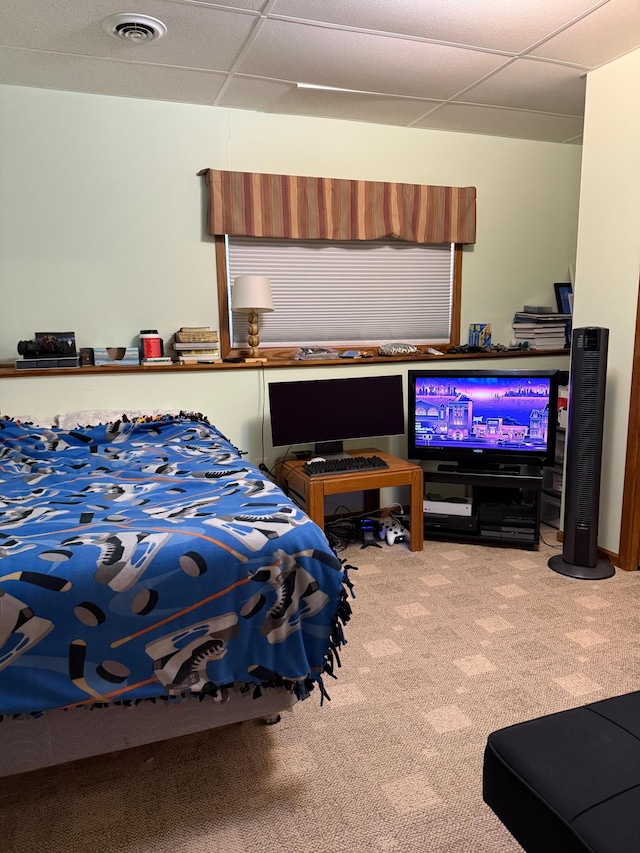 carpeted bedroom with visible vents and a paneled ceiling