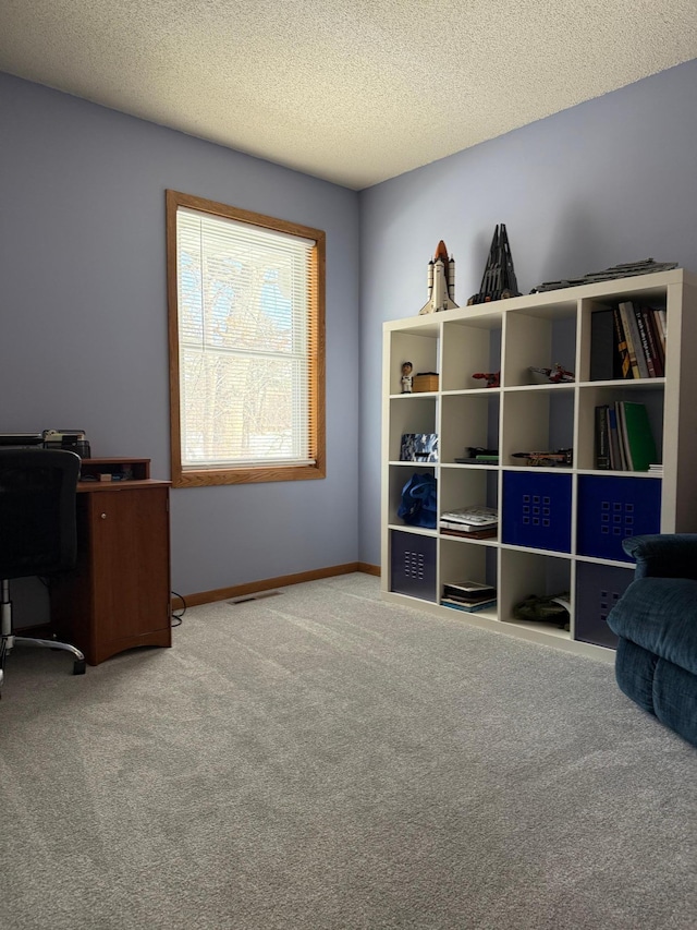 interior space with visible vents, baseboards, and a textured ceiling