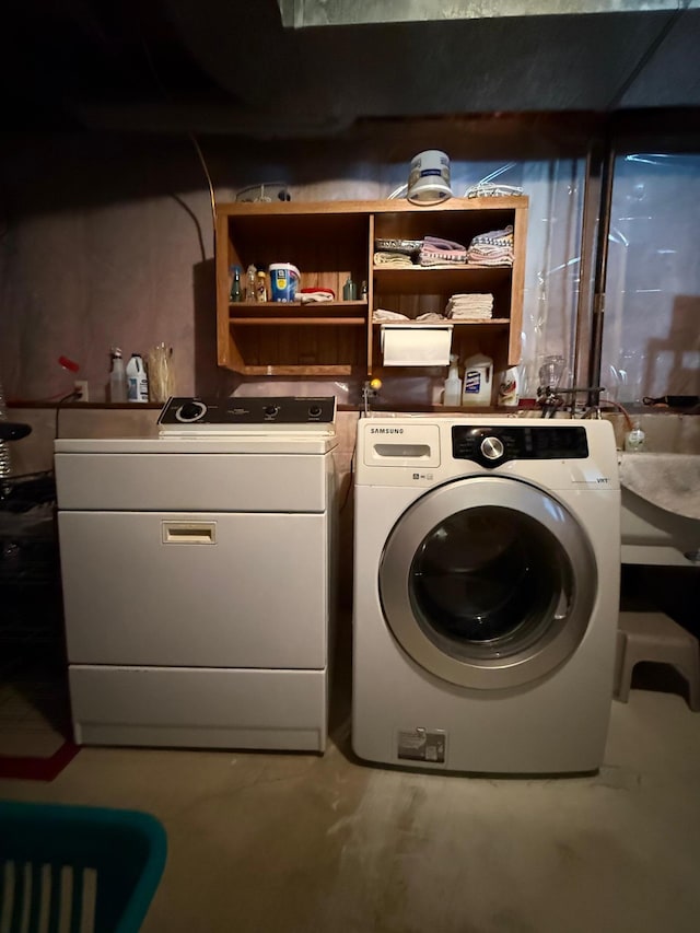 washroom featuring washing machine and clothes dryer and laundry area