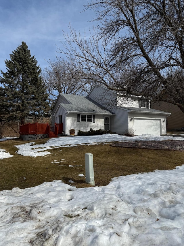 view of snow covered exterior featuring a garage and a wooden deck