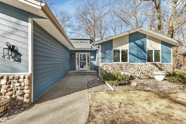 entrance to property with stone siding