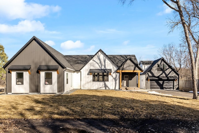 view of front of house featuring driveway, a front yard, a garage, and fence