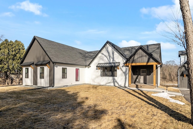 back of property featuring metal roof, a standing seam roof, and a shingled roof