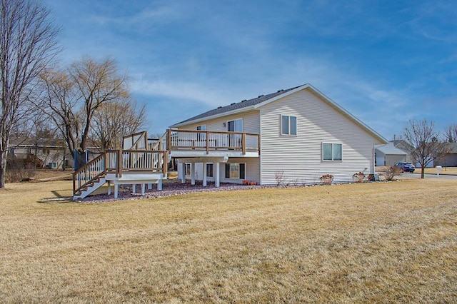 rear view of house with a wooden deck, stairs, and a yard