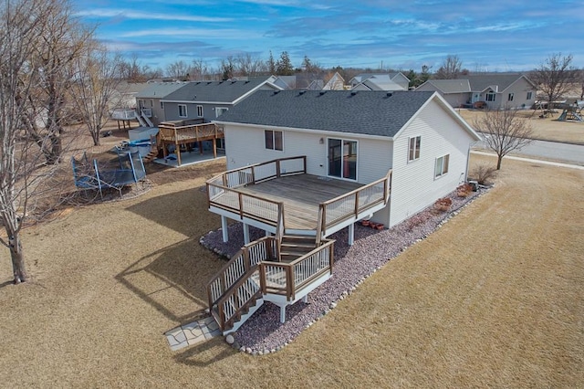 back of property featuring a residential view, roof with shingles, and a wooden deck