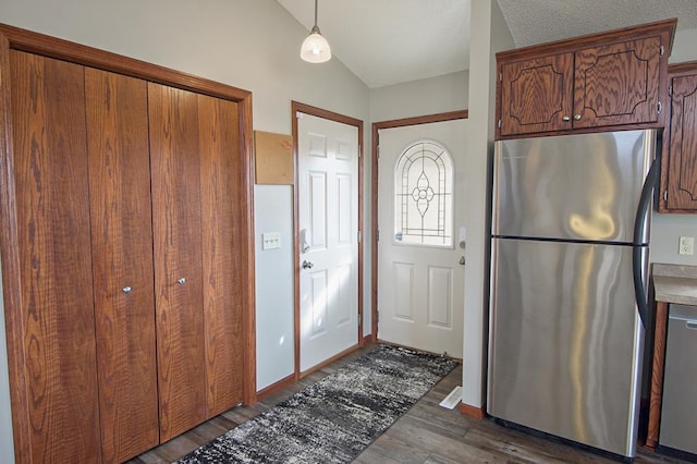 foyer featuring lofted ceiling and wood finished floors