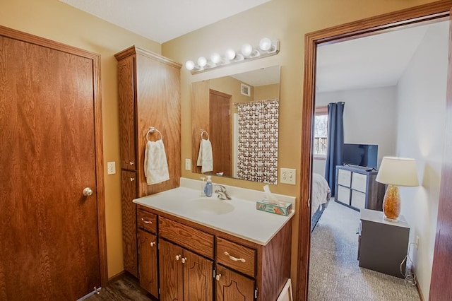 ensuite bathroom with ensuite bath, visible vents, and vanity