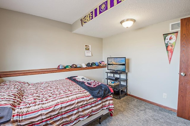 carpeted bedroom with visible vents, baseboards, and a textured ceiling