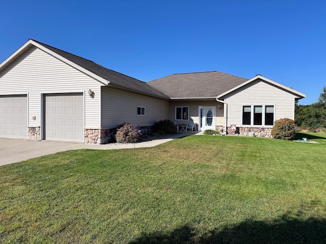 view of front facade with a front yard, a shingled roof, concrete driveway, a garage, and stone siding