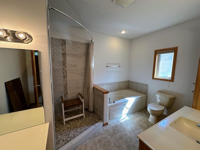 bathroom with vanity, tiled shower, toilet, a textured ceiling, and a bath