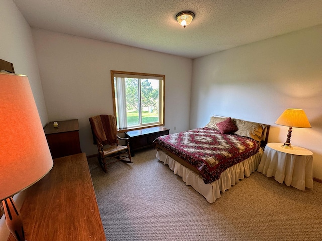 bedroom featuring light colored carpet and a textured ceiling