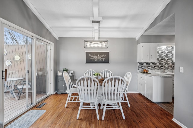 dining space with visible vents, ornamental molding, baseboards, and wood finished floors