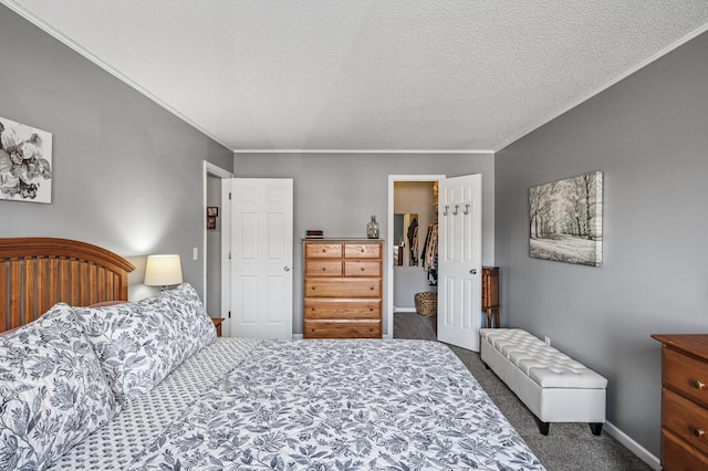 carpeted bedroom with crown molding, baseboards, and a textured ceiling