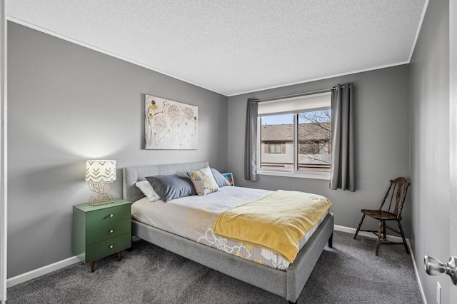 bedroom featuring ornamental molding, baseboards, dark carpet, and a textured ceiling