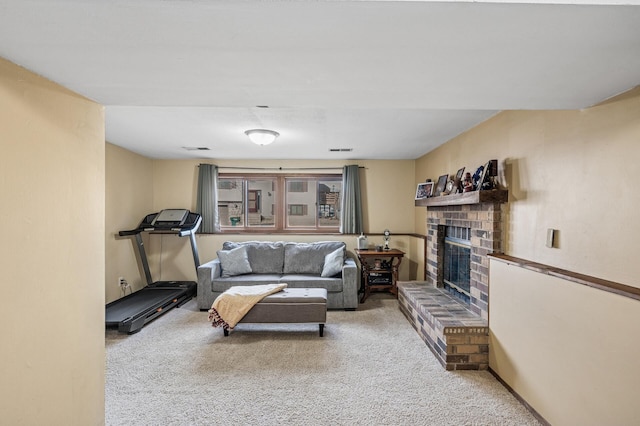 living room with carpet flooring, a fireplace, and visible vents