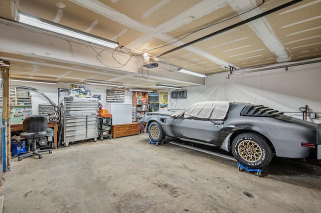 garage with a workshop area and a garage door opener