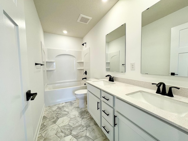 bathroom with a sink, visible vents, toilet, and double vanity