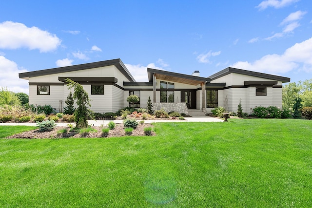 rear view of house featuring a lawn