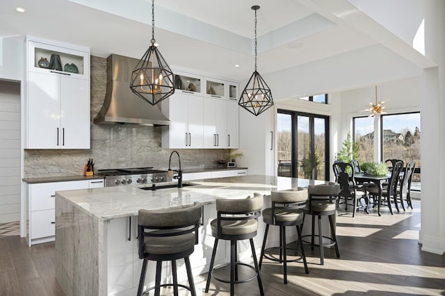 kitchen with a chandelier, range, wall chimney exhaust hood, and dark wood finished floors