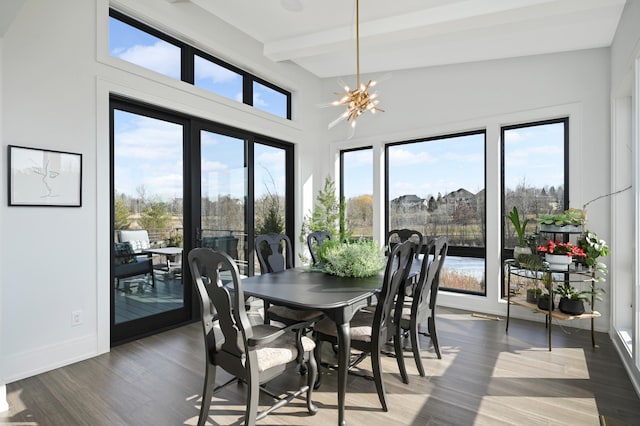 dining area with beamed ceiling, baseboards, an inviting chandelier, and wood finished floors