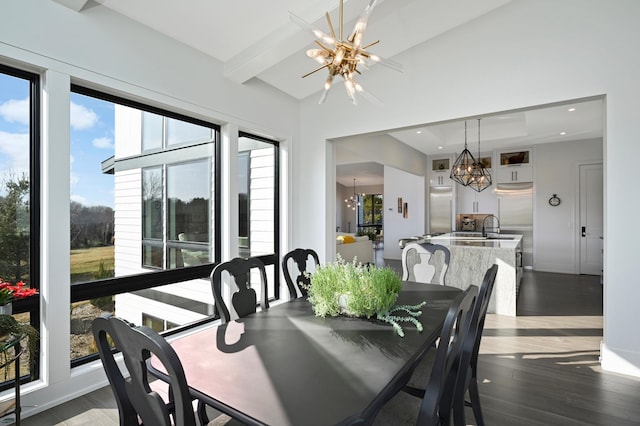 dining area with beamed ceiling, a notable chandelier, wood finished floors, recessed lighting, and baseboards