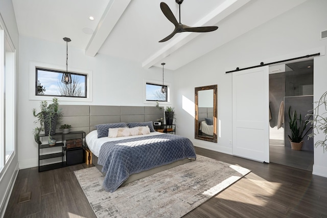 bedroom with visible vents, beam ceiling, dark wood finished floors, a barn door, and baseboards