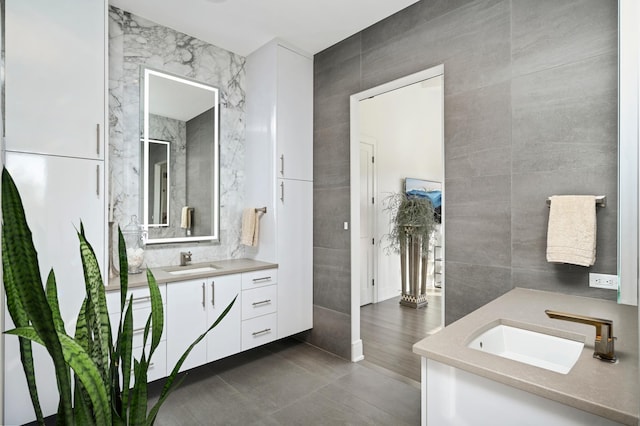 bathroom with tile walls and vanity