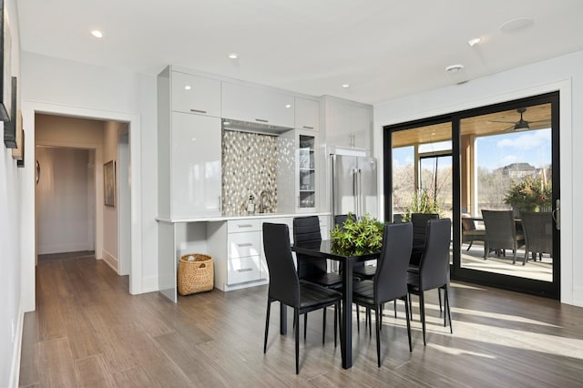 dining area featuring recessed lighting, wood finished floors, and baseboards